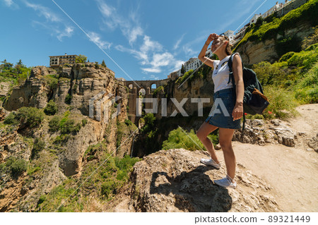 Tourist girl on the background of the famous bridge in Ronda, Spain Tourist girl on the background of the famous bridge in Ronda, Spain 89321449