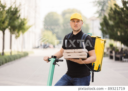 Male courier with pizza looking at camera 89321719