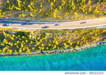 View of the road along the coast from the drone. Travel by car in summer time View of the road along the coast from the drone. Travel by car in summer time 89322233