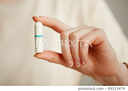 Hand Holding Tampon Closeup 89323474