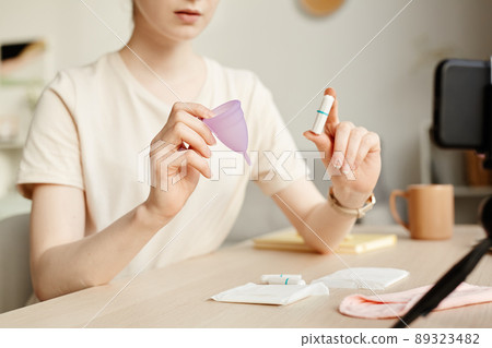 Young Woman Comparing Feminine Products Young Woman Comparing Feminine Products 89323482