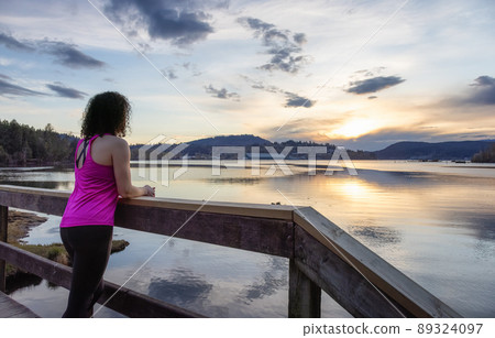 Woman on a Wooden Path looking at nature in Shoreline Trail Woman on a Wooden Path looking at nature in Shoreline Trail 89324097