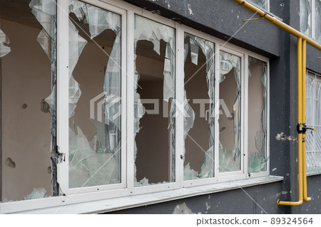 Aftermath bombed building window shatter glass damage building destruction Ukraine war Russia shooting civilian shell. Smashed window broken glass break. Destroyed building broken frame window plastic Aftermath bombed building window shatter glass damage building destruction Ukraine war Russia shooting civilian shell. Smashed window broken glass break. Destroyed building broken frame window plastic 89324564