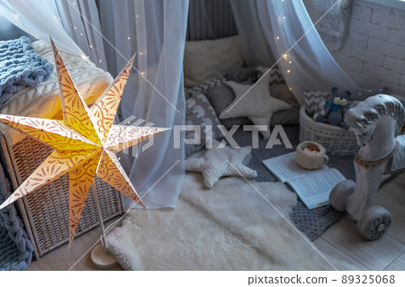 Childen's room corner with a beautifully decorated play tipi tent. Wigwam 89325068