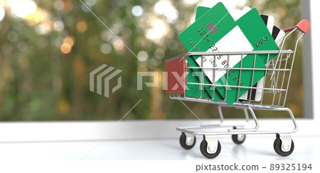 Bank card mockups with flags of Nigeria in a small shopping cart. 3D rendering Bank card mockups with flags of Nigeria in a small shopping cart. 3D rendering 89325194