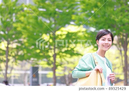 Fresh green city_Woman walking with a smile 4 89325429