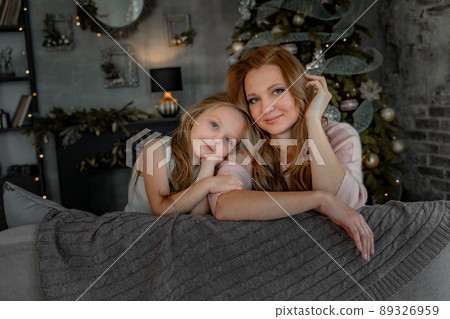 Head shot portrait beautiful young mother embrace little daughter supporting and caring sitting in living room at home spend time together. 89326959