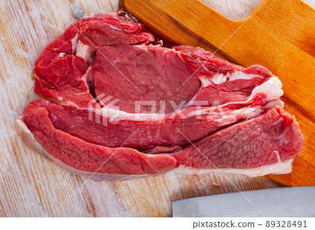 Raw beef entrecote steak ready for cooking on wooden surface Raw beef entrecote steak ready for cooking on wooden surface 89328491