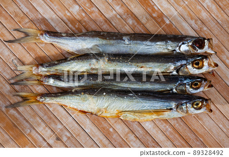 Several dried salted sabrefish on wooden background Several dried salted sabrefish on wooden background 89328492