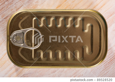 Golden tin can on table 89328520