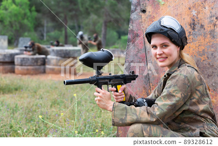 Portrait of girl in camouflage on paintball field Portrait of girl in camouflage on paintball field 89328612