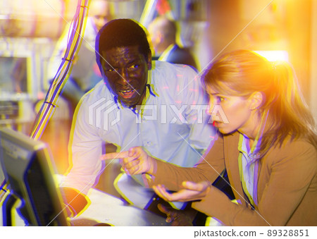 Man and woman in fright looking for a solution on the computer in quest room 89328851