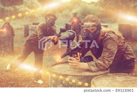 Portrait of girl in camouflage on paintball field Portrait of girl in camouflage on paintball field 89328901