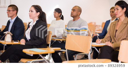 Business people listening to speaker at conference Business people listening to speaker at conference 89328959