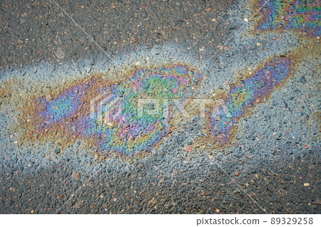 Rainbow gasoline oil spill on the pavement as a texture or background. 89329258