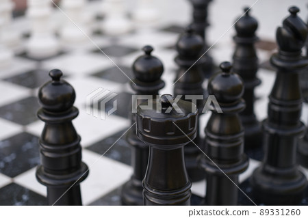 Chessboard with chessmen, chess battle white against black Chessboard with chessmen, chess battle white against black 89331260