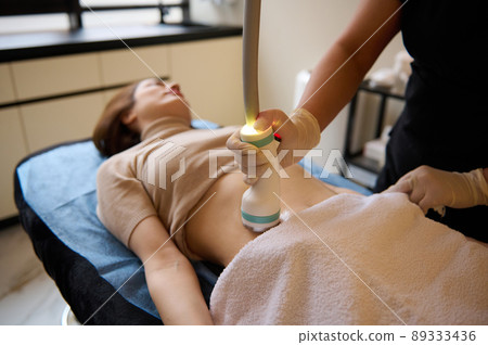 Beautiful woman receiving hardware spa procedure for cellulite reduction and weight loss in medical clinic 89333436