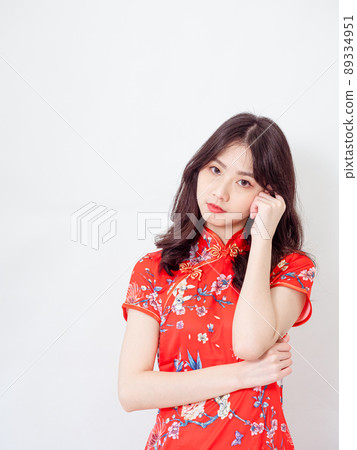 Portrait of Young asian woman wearing traditional cheongsam qipao dress thinking with hand on head isolated over white background. Portrait of Young asian woman wearing traditional cheongsam qipao dress thinking with hand on head isolated over white background. 89334951