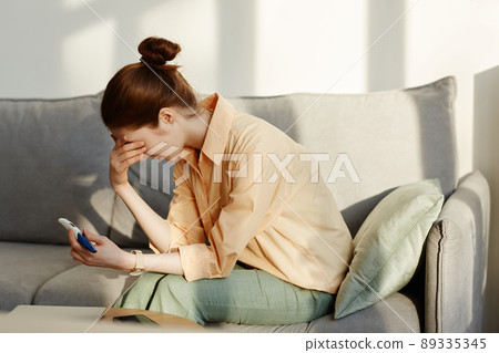Depressed Young Woman Holding Pregnancy Test 89335345
