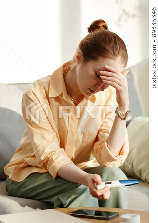 Frustrated Woman Holding Pregnancy Test 89335346
