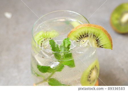 Kiwi mojito cocktail or caipirinha drink recipes with mint and ice in glasses close up. Summer cold drink kiwi lemonade 89336583