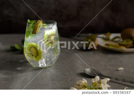 Kiwi mojito cocktail or caipirinha drink recipes with mint and ice in glasses close up. Summer cold drink kiwi lemonade 89336587