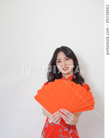 A woman with a traditional flag, a red envelope with a white background, and a red envelope with a white background. 89336662