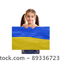 Girl holding Ukrainian blue and yellow flag 89336723