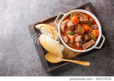 Daube de Boeuf Provencale slow cooked Rich Beef Stew closeup in the wooden tray. Horizontal top view Daube de Boeuf Provencale slow cooked Rich Beef Stew closeup in the wooden tray. Horizontal top view 89337038