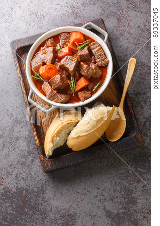 Daube Provencal French stew beef with vegetables is slow simmered to tenderness closeup in the wooden tray. Vertical top view 89337045