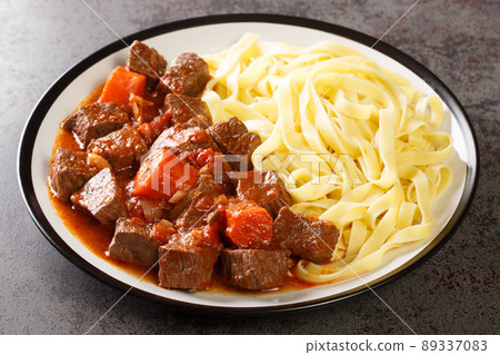 Provencal Beef Stew Daube served with noodles closeup in the plate. Horizontal Provencal Beef Stew Daube served with noodles closeup in the plate. Horizontal 89337083