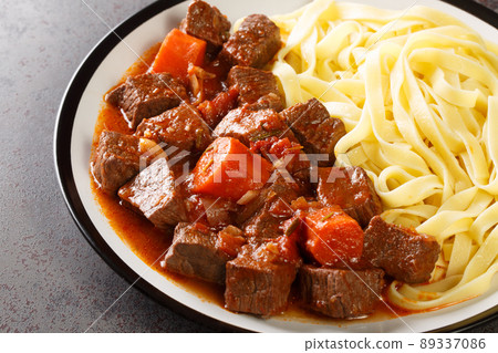 Daube de Boeuf Provencale slow cooked Rich Beef Stew with noodles closeup in the plate. Horizontal 89337086