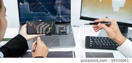 Two business colleagues pointing stock data chart on smartphone to checking data stock market and discussion Two business colleagues pointing stock data chart on smartphone to checking data stock market and discussion 89338061