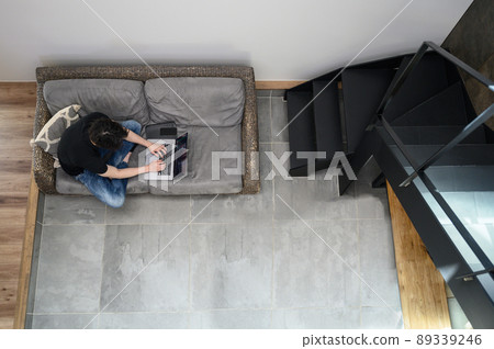 A bird's-eye view of a man who works on a personal computer A bird's-eye view of a man who works on a personal computer 89339246