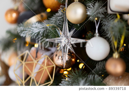 Christmas tree decoration close up background. Garland, balls, illuminated lights 89339718