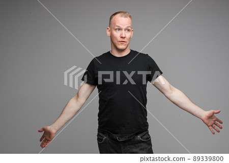Confused Caucasian man with outstretched arms. 89339800