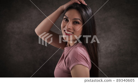 Happy young woman looks into the camera Happy young woman looks into the camera 89340605