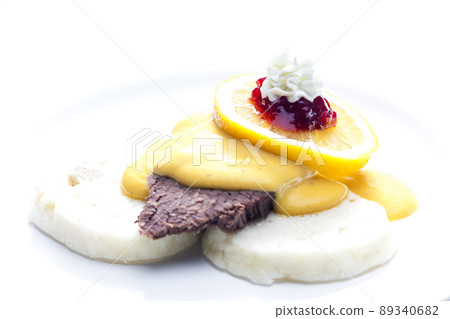 sirloin cream sauce with dumplings served with lemon, cranberries and whipped cream 89340682