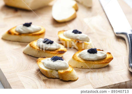 anchovy spread on toasted baguette slices 89340713