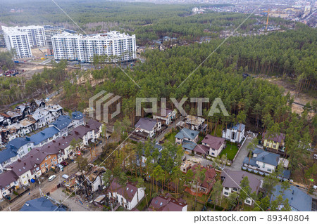 Top view of the destroyed and burnt houses. Houses were destroyed by rockets or mines from Russian soldiers. Cities of Ukraine after the Russian occupation. Top view of the destroyed and burnt houses. Houses were destroyed by rockets or mines from Russian soldiers. Cities of Ukraine after the Russian occupation. 89340804