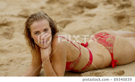Sexy girl poses for the camera - happy girl on summer vacation at the beach Sexy girl poses for the camera - happy girl on summer vacation at the beach 89340839