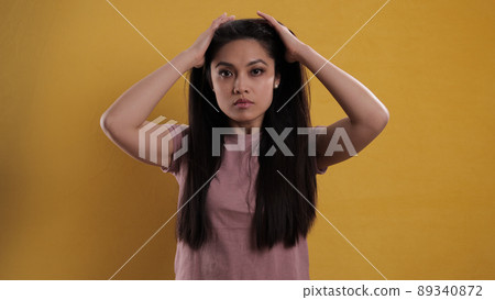 Portrait of a young beautiful woman against a neutral background 89340872
