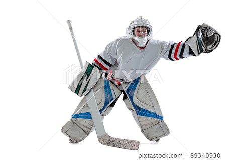 Dynamic portrait of teen boy, hockey player, goalkeeper catching puck with special glove isolated over white studio background 89340930