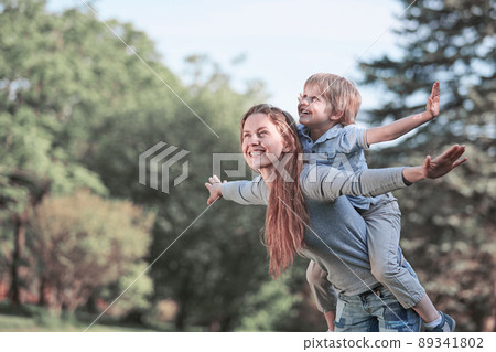 happy mom playing with her son in the summer Park . 89341802