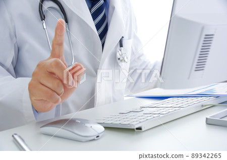Male doctor raising his index finger 89342265
