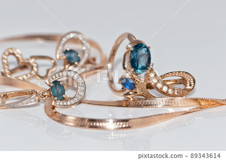 Gold earrings and ring with blue Topaz 89343614