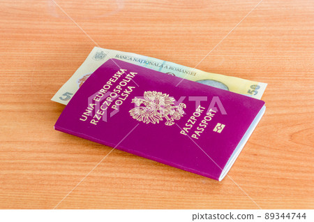 Polish biometric passport with 50 Romanian lei banknote (RON). 89344744