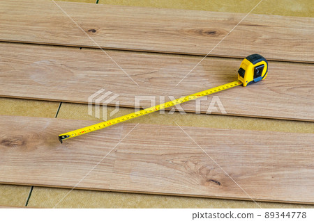 Tape measure on floor panels when laying them on the floor. 89344778