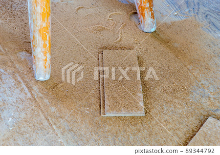 Chips on the floor after cutting floor panels. 89344792