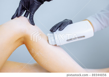 Sugaring: woman at cosmetics salon waxing legs Sugaring: woman at cosmetics salon waxing legs 89344856